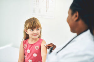 Little girl smiling at her doctor