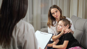 Mother listens to doctor prescribing medication