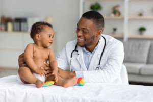 Doctor Making Check Up For Infant Baby Boy