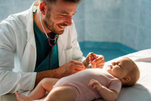 Pediatric doctor exams little baby