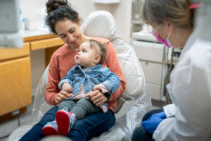 Cute toddler and mom at pediatric dental appointmen