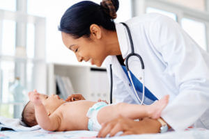 Keeping baby healthy and happy - Doctor doing wellness checkup of baby